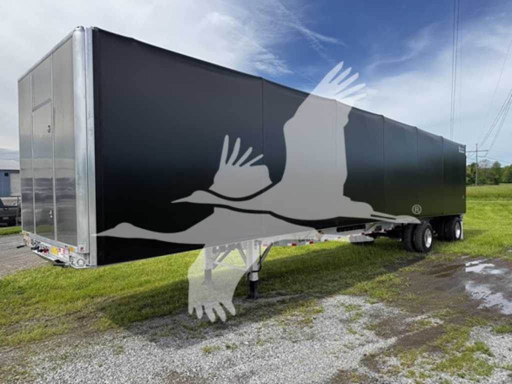 Curtainside trailer with black exterior and graphic of birds in flight showing the Reitnouer CK-100 model.