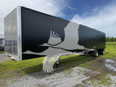 Curtainside trailer with black exterior and graphic of birds in flight showing the Reitnouer CK-100 model.