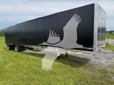 Curtainside trailer showing black paint with white graphic of birds in flight and silver front panel.