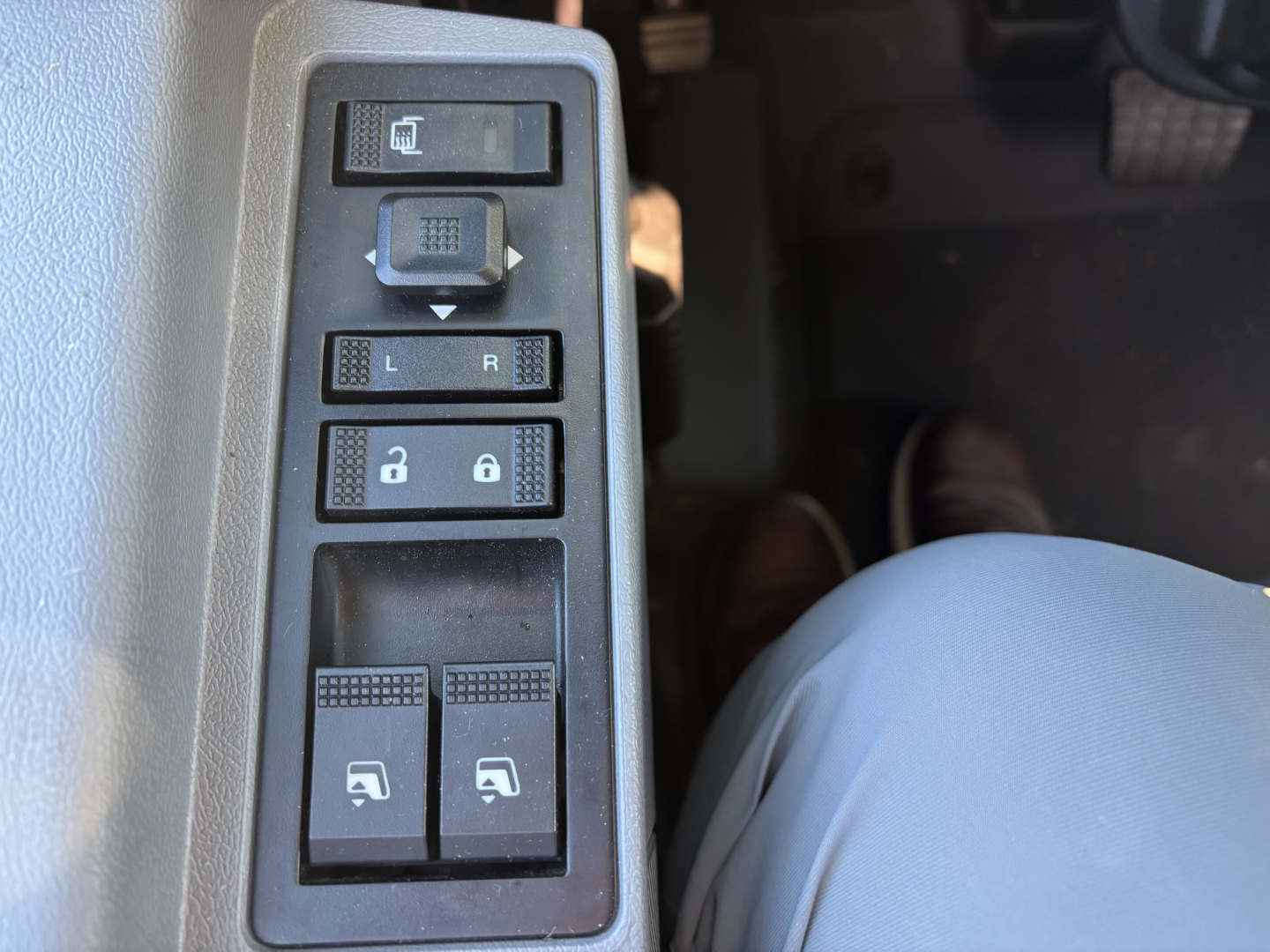 Truck interior side panel showing window/lock switches and mirror controls on Mack GR64B cab cab panel.