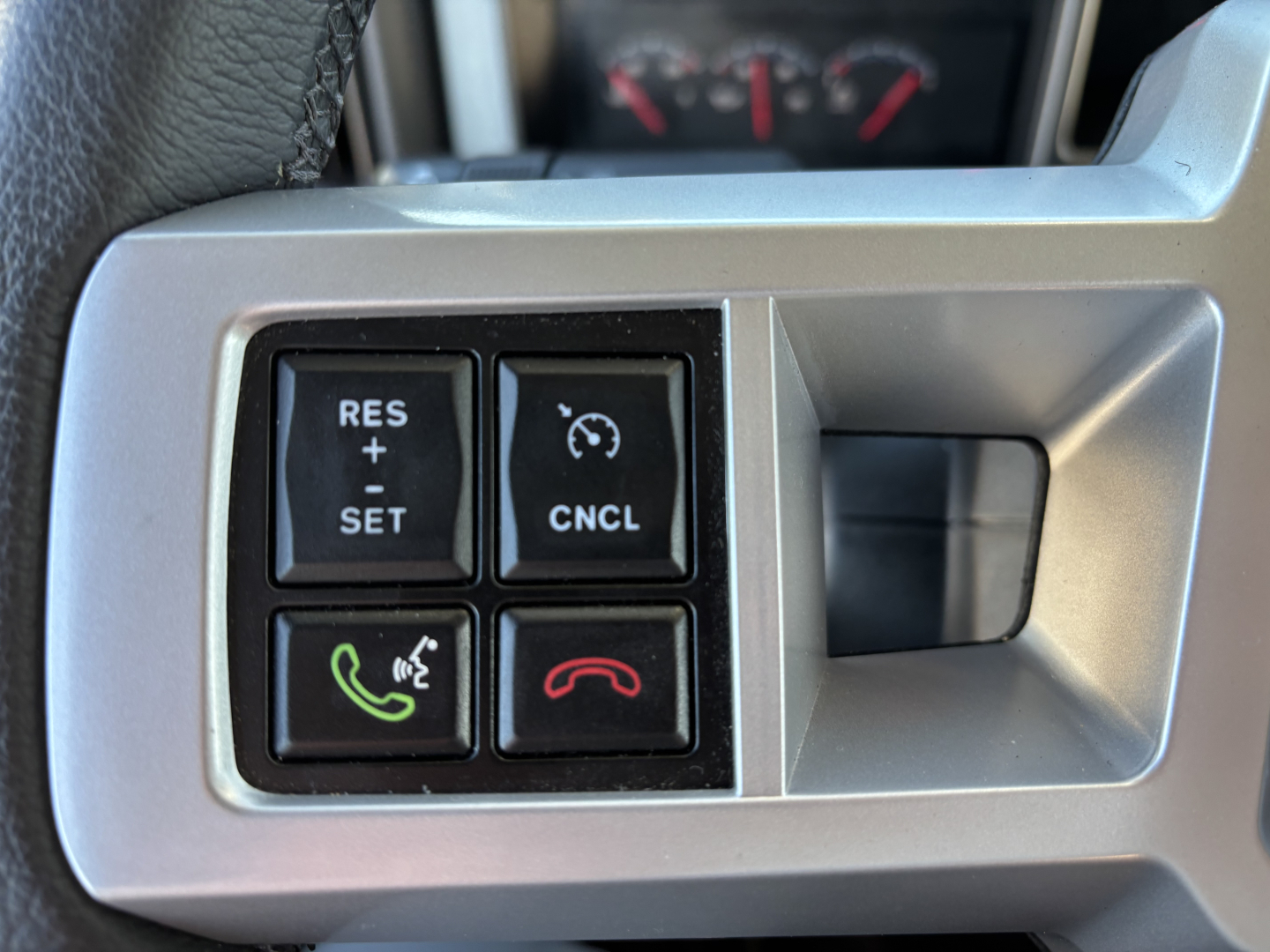 Dash steering wheel controls on a 2025 Mack GR64B cab and chassis showing cruise control buttons, phone pick-up, and end call symbols.