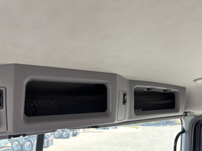 Cab and chassis interior overhead storage compartments with mesh panels and latches, interior roof panel visible.