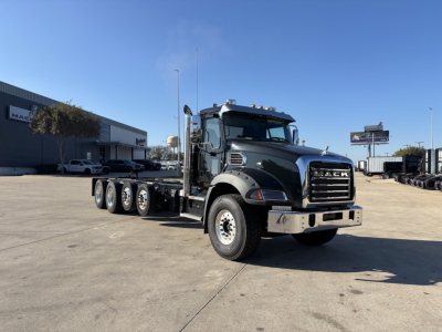 2025 Mack GR64B cab and chassis truck showing front grille with Mack logo and six-wheel configuration in a dealership lot.