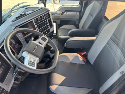 Cab and chassis interior of a 2025 Mack GR64B showing steering wheel, instrument cluster, center console, and driver seat.