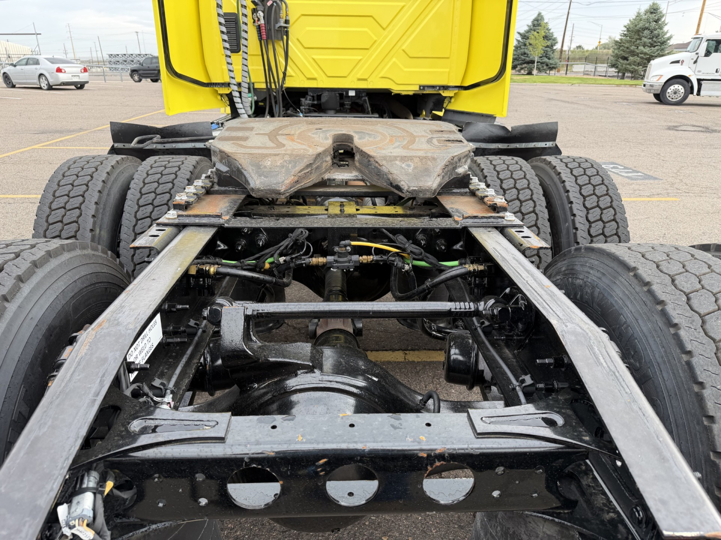 Truck frame and rear drivetrain showing fifth wheel area and suspension of a 2023 International LT625 conventional daycab.