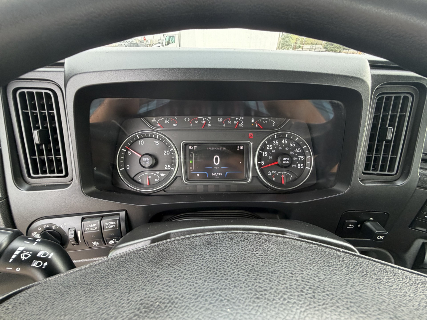 Dashboard of a 2023 International LT625 truck showing instrument cluster and steering wheel; visible text includes odometer reading 0, various gauges, and a digital display.
