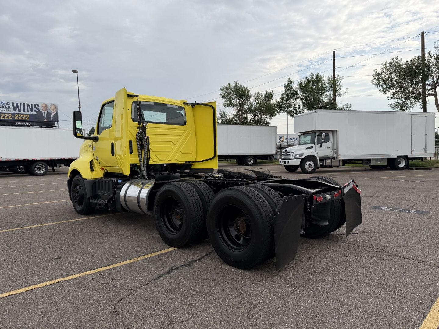 International LT625 truck tractor chassis rear view showing dual rear axles and yellow cab.