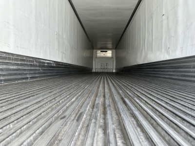 Trailer interior showing ribbed floor of a 2018 Utility 3000R reefer trailer with white walls and rear door.