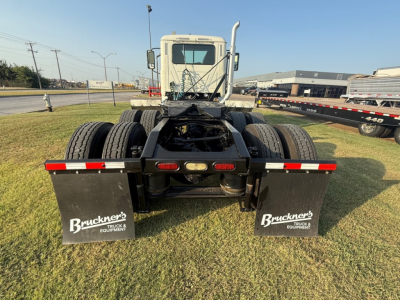 Rear view of a 2020 Mack PI64T truck tractor showing dual rear axles, mudflaps with Bruckner's Truck & Equipment logos, and brake/taillight assembly.