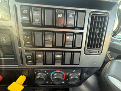 Dashboard of a 2020 Mack PI64T showing control switches and climate controls; no legible VIN or serials visible in image.