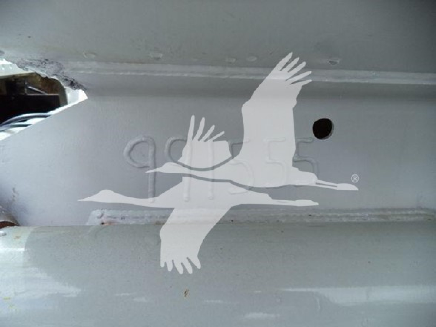 Image shows a metal truck frame with a watermark of birds overlay; no visible text or model-specific labels in view.