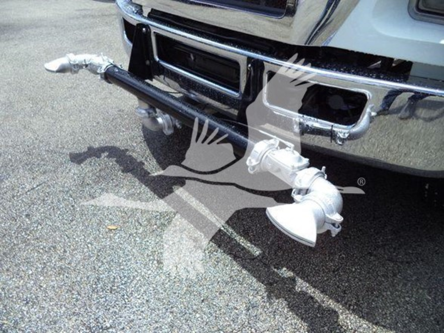 Front bumper of a Ford F650 with a metal towing or plow accessory attached, showing chrome bumper and hitch components.