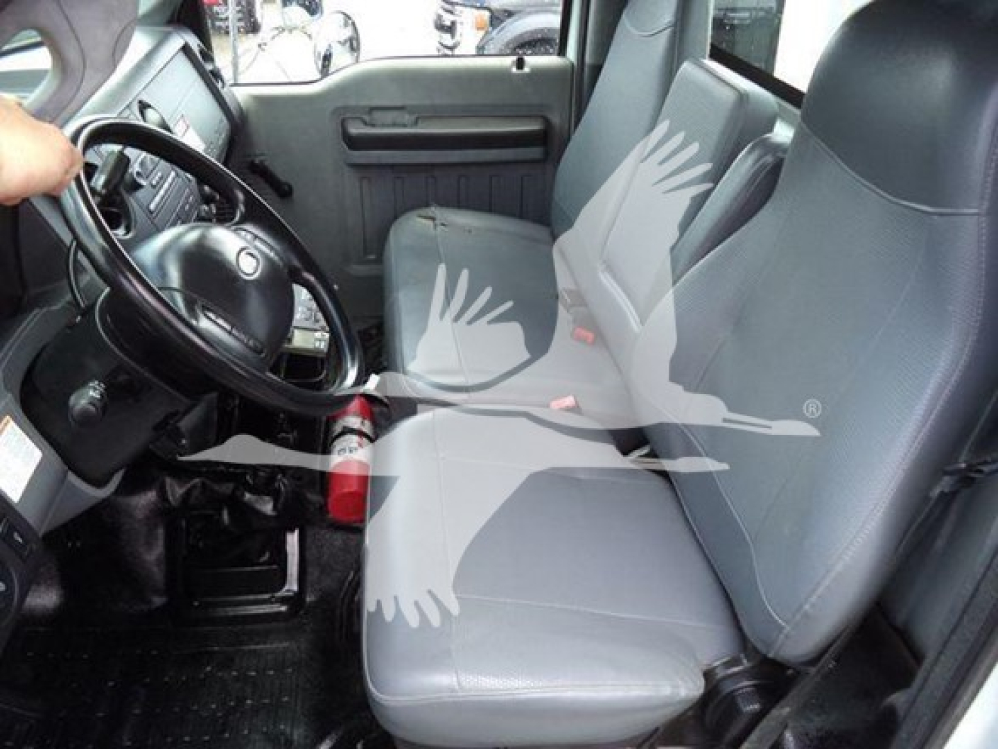 Interior of a 2015 Ford F650 cab showing front seats and steering wheel.