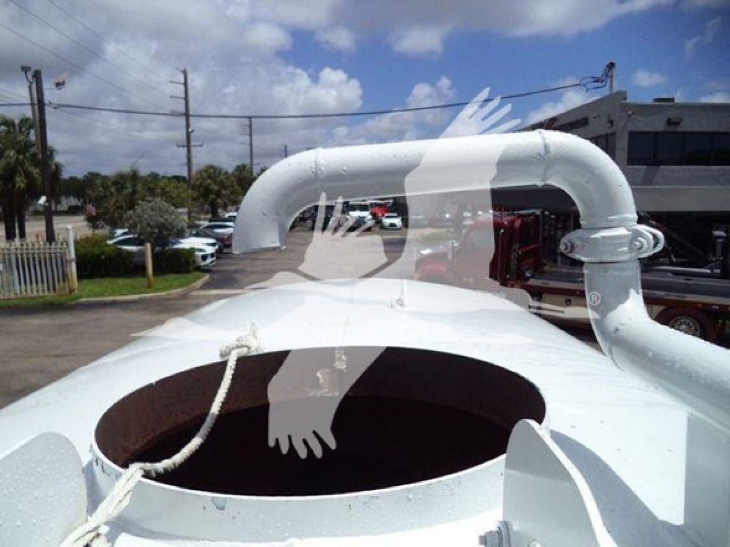 Open top of a white Ford F650 engine or cab with large circular opening and piping; no legible model text visible.