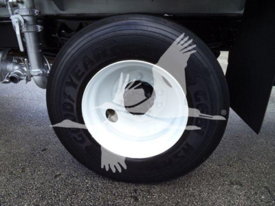 Front wheel and tire of a 2015 Ford F650 Sd showing Goodyear tire and white steel rim with hub area visible.