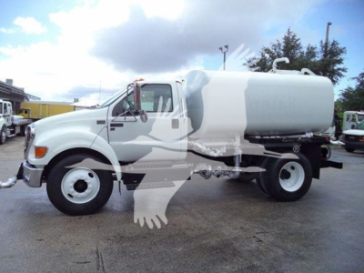 2015 Ford F650 SD truck with a large cylindrical tank on the back, white in color, side view.