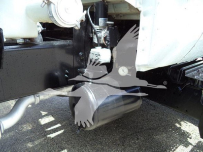 Truck wheel area showing front drive axle with suspension and engine bay components; partial white body, black frame, water category listing visible.