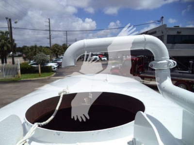 Open top of a white Ford F650 engine or cab with large circular opening and piping; no legible model text visible.