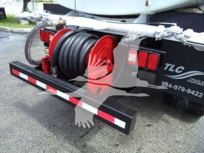 Rear view of a 2015 Ford F650 truck with a large hose reel and reel hose mounted on a bumper, water truck equipment with TLC branding and a reel mounted on the back.