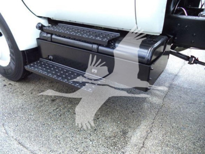 Truck side view showing a step with metal treads and a black rectangular storage box under the cab near the running board.