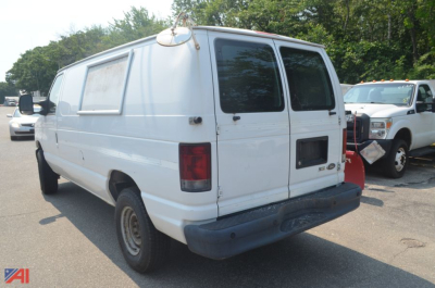 Ford E350 cargo van rear view showing dual rear doors, white body, and black bumper with taillights.