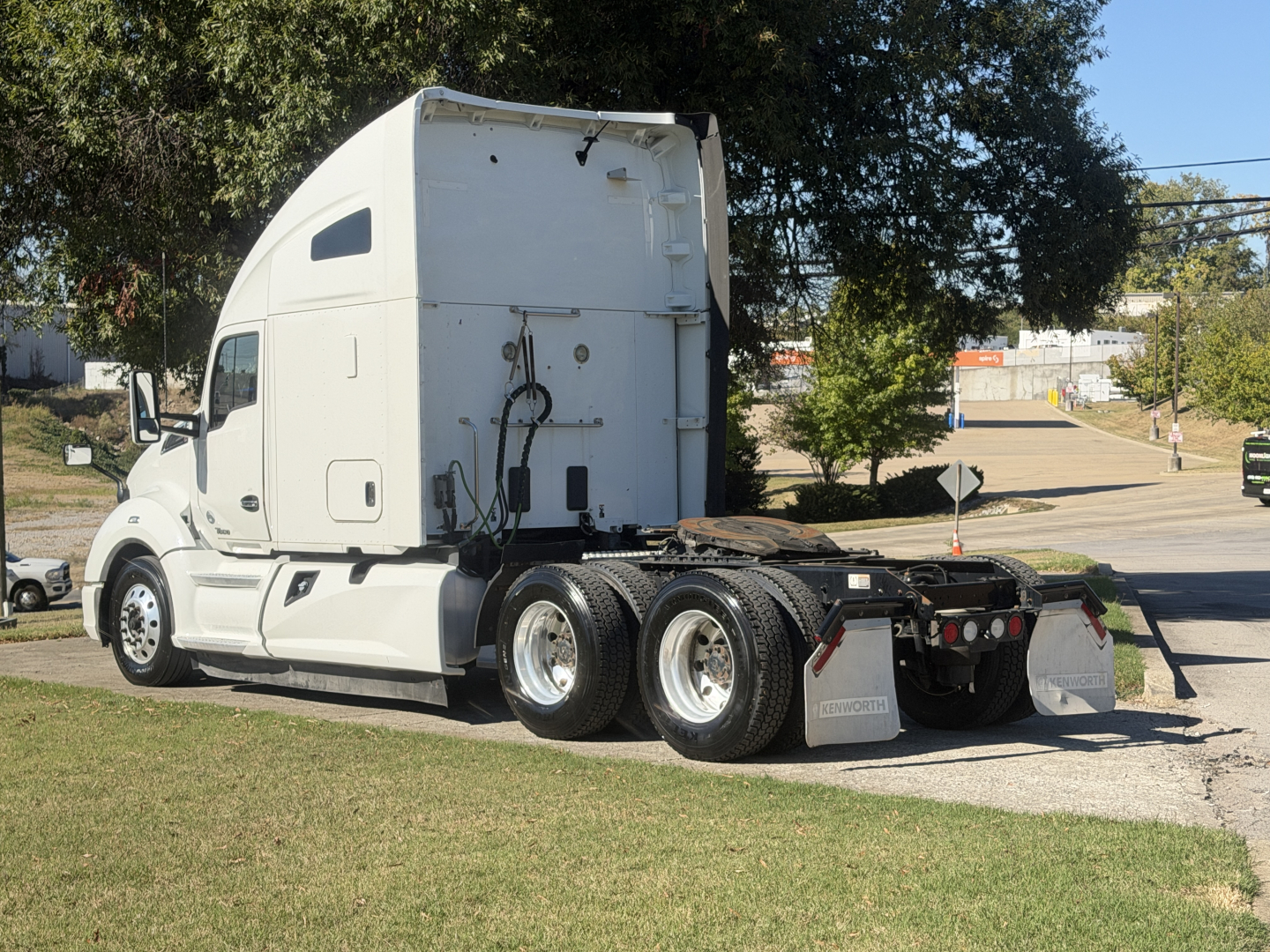 Kenworth T680 tractor semi-truck side/rear view showing sleeper cab, white exterior, used vehicle, no visible text on labels