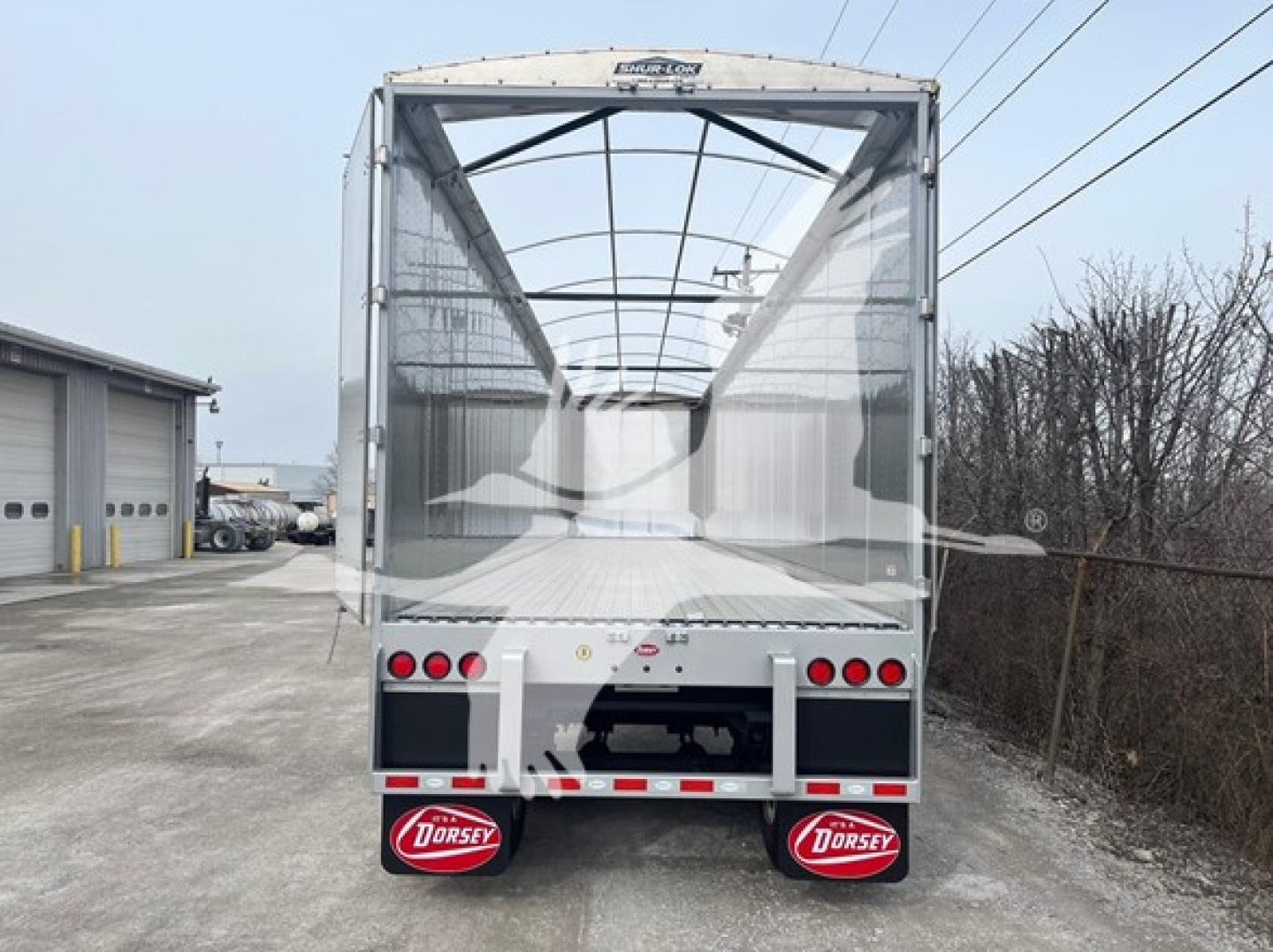 Back view of a new 2027 Dorsey walking floor trailer with VIN 7KYCW4529VED48298 and stock number VED48298, aluminum body, open floor, taillights, and Dorsey mud flaps.