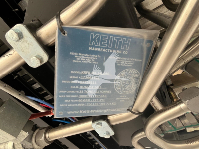 Keith Manufacturing Co. tag on a walking floor trailer showing model KRFL-? with serial number 173? drive capacity, max flow, and other specs.
