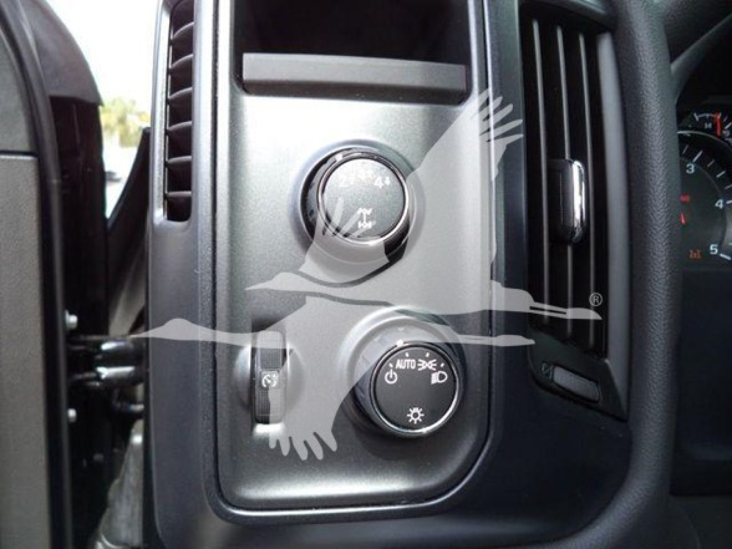 Dashboard controls of a 2023 International CV vehicle showing headlight and dimmer switches.