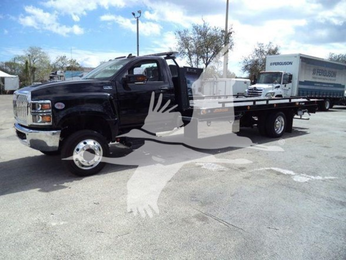 Heavy-duty tow truck/almost-new rollback service truck with flatbed, cab in black, showing VIN and stock number area (1HTKTSWK6PH441635).