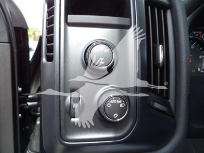 Dashboard controls of a 2023 International CV vehicle showing headlight and dimmer switches.