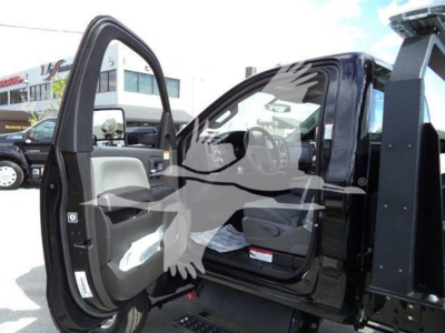 Truck cab interior with open door showing steering wheel, seats, and dashboard in a new 2023 International CV rollback truck.