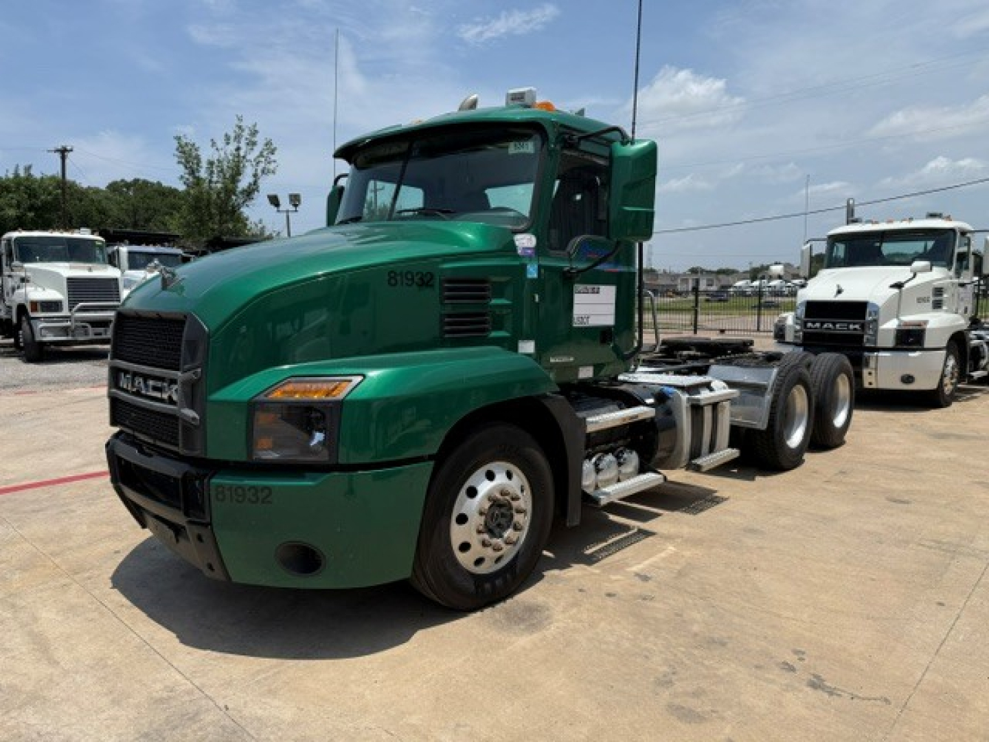 Green Mack ANTHEM daycab truck from a side-front view; visible text includes 'MACK' on grille and '81932' stenciled on door; no other legible labels or fluids seen.