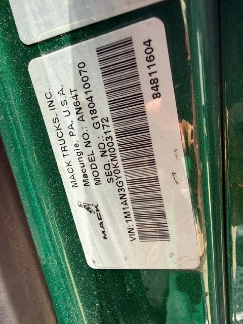 Mack ANTHEM truck label with VIN 1M1AN3GY0KM003172 and barcode sticker on green vehicle; stock number B3742L and MACK TRUCKS INC information visible.