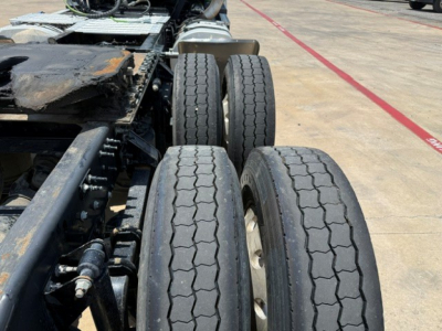 Trucks axle and dual rear wheels of a 2019 Mack Anthem tractor show tires and suspension components in view.