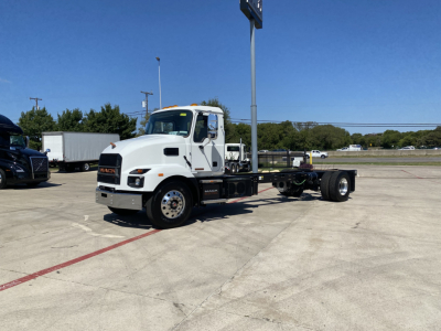 Cab and chassis truck showing white Mack MD6 frame and front wheel area with chassis rails visible and blank rear axle area, no freight cab.