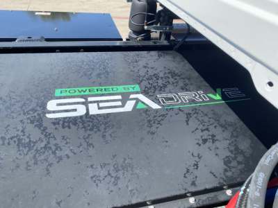 Powertrain sticker reading 'POWERED BY SEA DRIVE' on black surface of Mack MD6 E cab chassis.