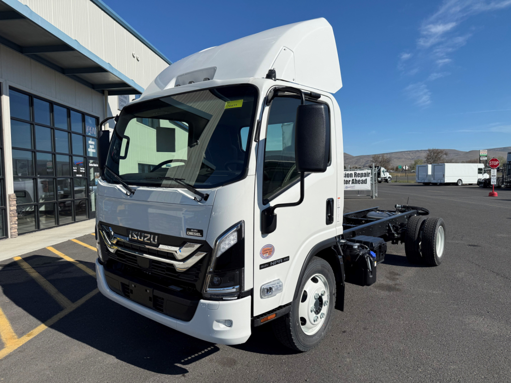Isuzu NPRXD cab chassis truck in white showing front and driver side, with raised cab roof and chassis behind; no visible text on doors.