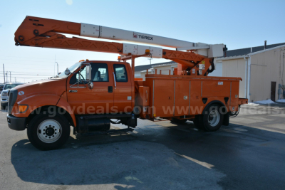 Ford bucket truck with boom arm labeled 'Terex' mounted on orange utility body, side view showing wheel, cab, and compartments.
