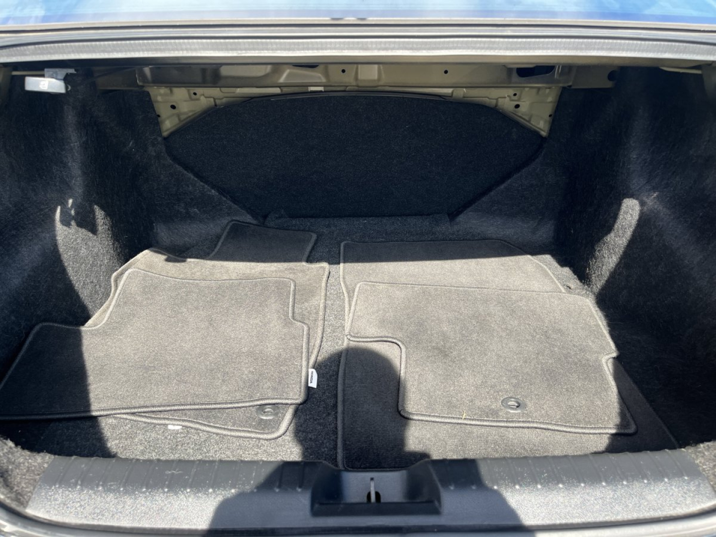 Trunk/storage area of a 2015 Honda Civic Coupe showing carpeted floor with folded rear hatch area and trunk space, no visible fluids or labels.