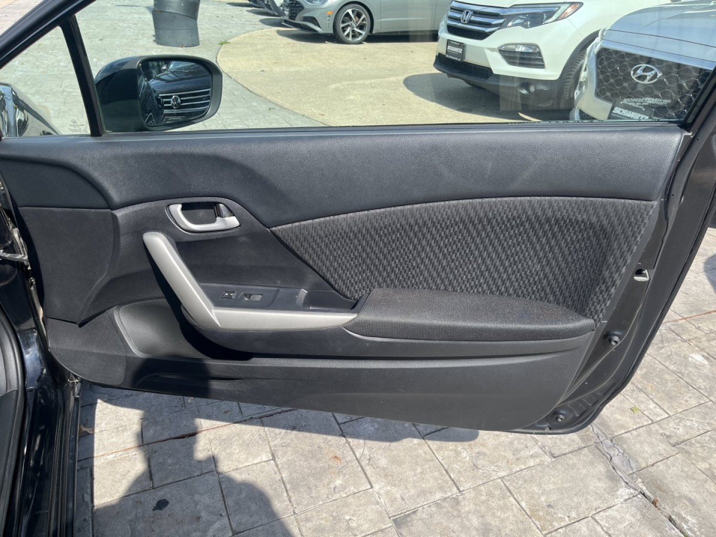 Honda Civic driver-side front door interior panel with armrest and window controls visible