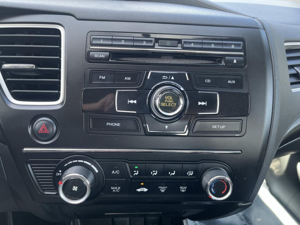 Dashboard center console of a 2015 Honda Civic Coupe showing radio controls, climate control knobs, and USB/CD/AUX buttons.