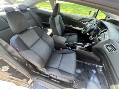 Interior of a used 2015 Honda Civic Coupe showing front seats, dashboard, steering wheel, and center console.