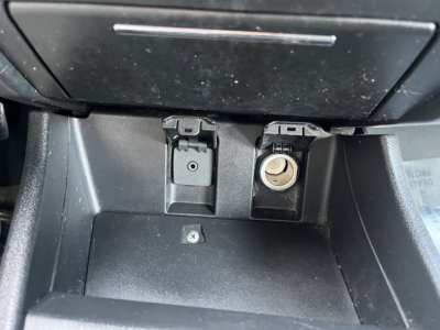 Honda Civic dashboard area showing 12V power outlet and auxiliary port in center console.