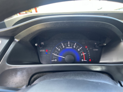 Dashboard of a 2015 Honda Civic Coupe showing analog tachometer with blue accents and gear selector indicators.