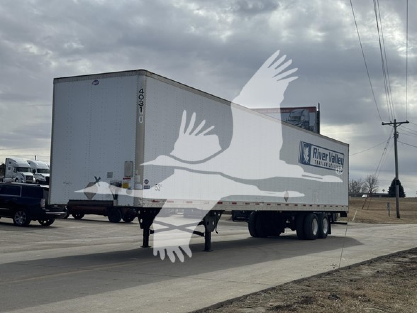 Utility 4000Dx trailer in side view showing River Valley Transportation logo and trailer identification numbers.