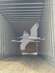 Trailer interior showing spacious cargo area with ribbed metal walls and a bird watermark graphic.