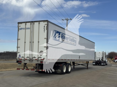 Trailer showing River Valley Transport trailer with white exterior and gray accents, rear doors closed, dual rear wheels.