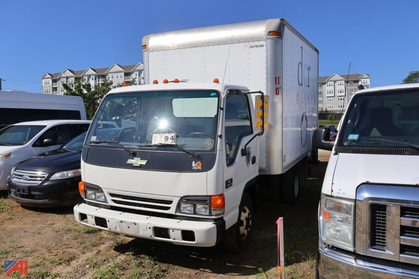 Box truck cab over featuring 2005 Chevrolet W4500 with box cargo area, front view showing Chevrolet emblem and grille, side mirrors, and box-rig with white cab.