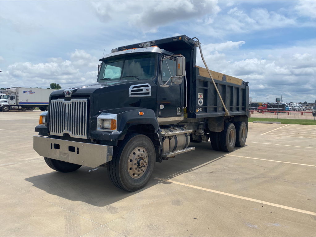 2018 Western Star 4700SF dump truck in a parking lot showing dump bed and dual rear wheels